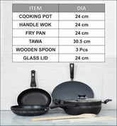 Set of black non stick cookware including a frying pan, wok, tawa, wooden spoon, and glass lid on a white surface with a tiled wall background.